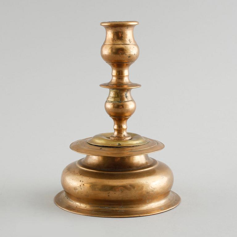 A 18th century baroque candlestick in brass.