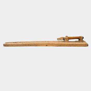 A Swedish folk art mangle board with carved decorationd, owners' initials and the date 1744.