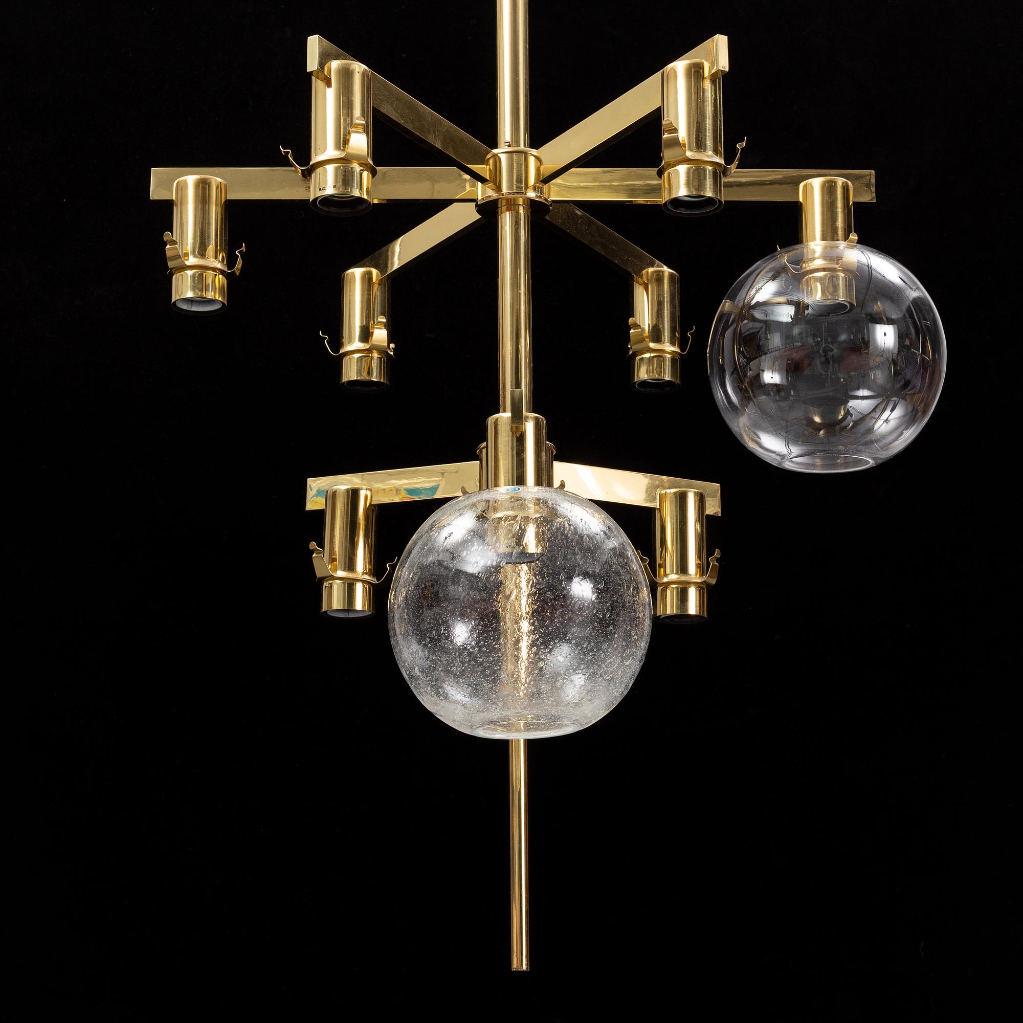 A brass chandelier with two glass globes by Hans-Agne Jacobsson, Markaryd.