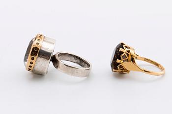 2 RINGS, 18K gold w smoky quartz approx 14 mm, silver and gold w rock crystal approx 16 mm, Stockholm 1963.