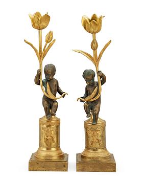 671. A pair of Louis XVI late 18th century candlesticks.