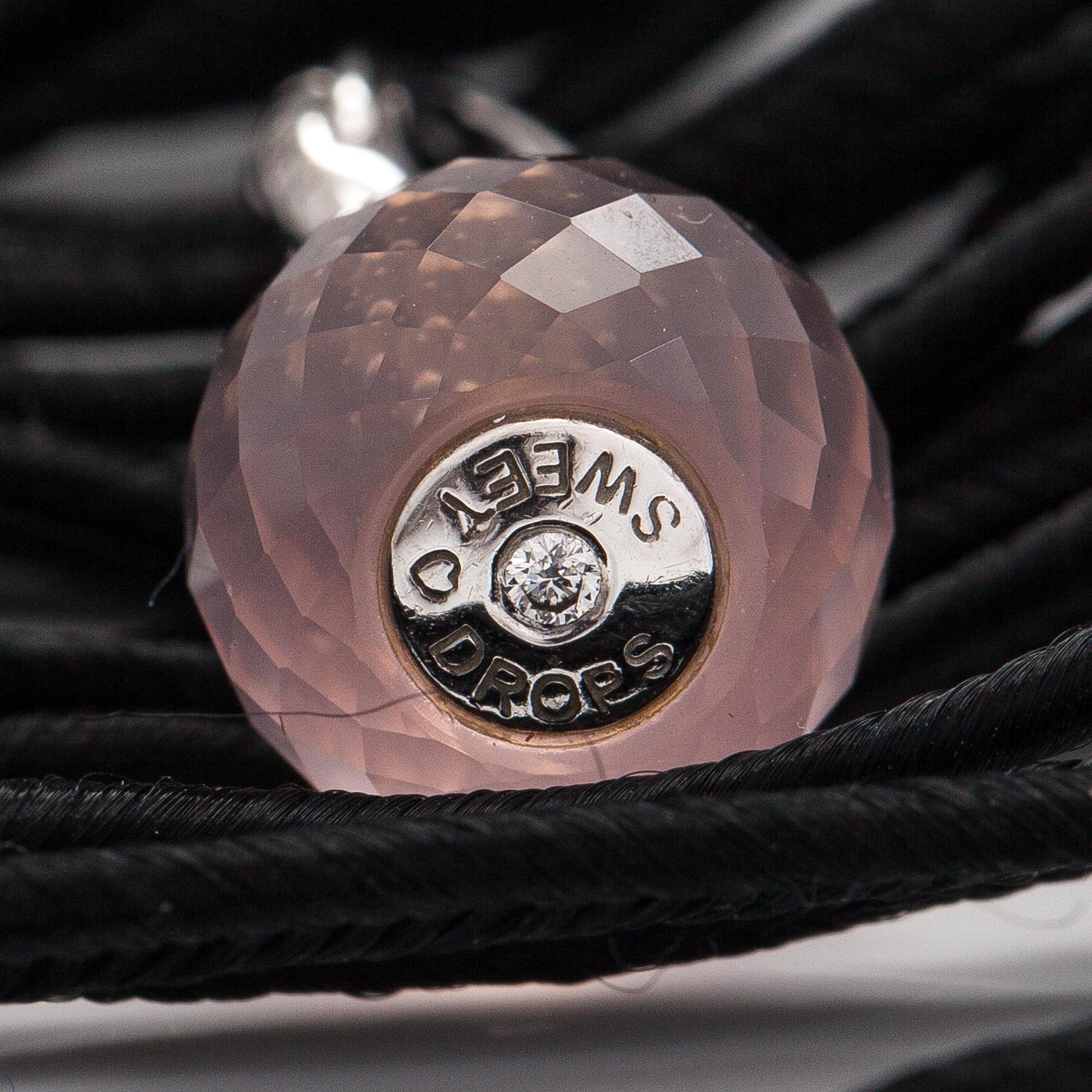 Ole Lynggaard, A satin like band bracelet with an 18K white gold and rose quartz "Sweet drops" pendant.