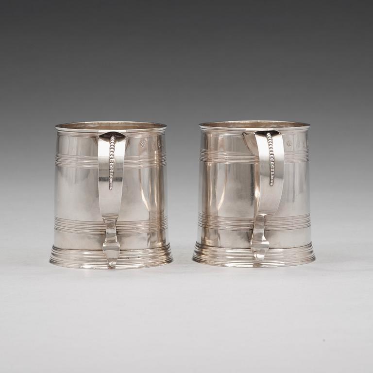 A pair of English early 18th century silver muggs, mark of John Cory, London 1704.