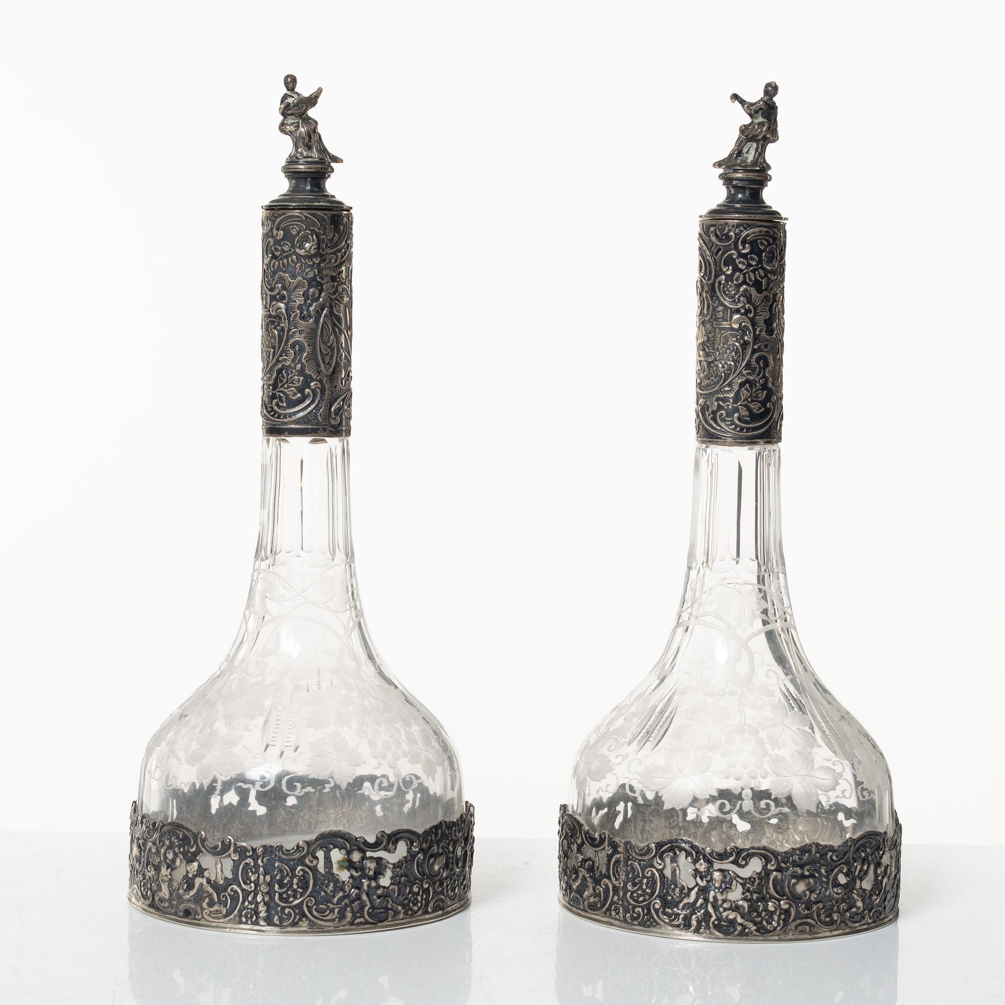 A pair of glass decanters with silver mounts, Swedish import marks, CG Hallberg, early 20th Century.