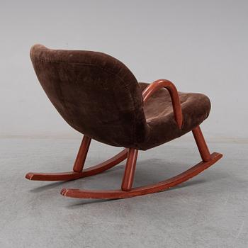 A "Clam chair" mid 20th century rocking chair.