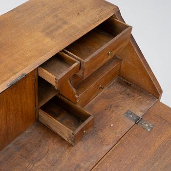 An oak secretaire, around 1800.