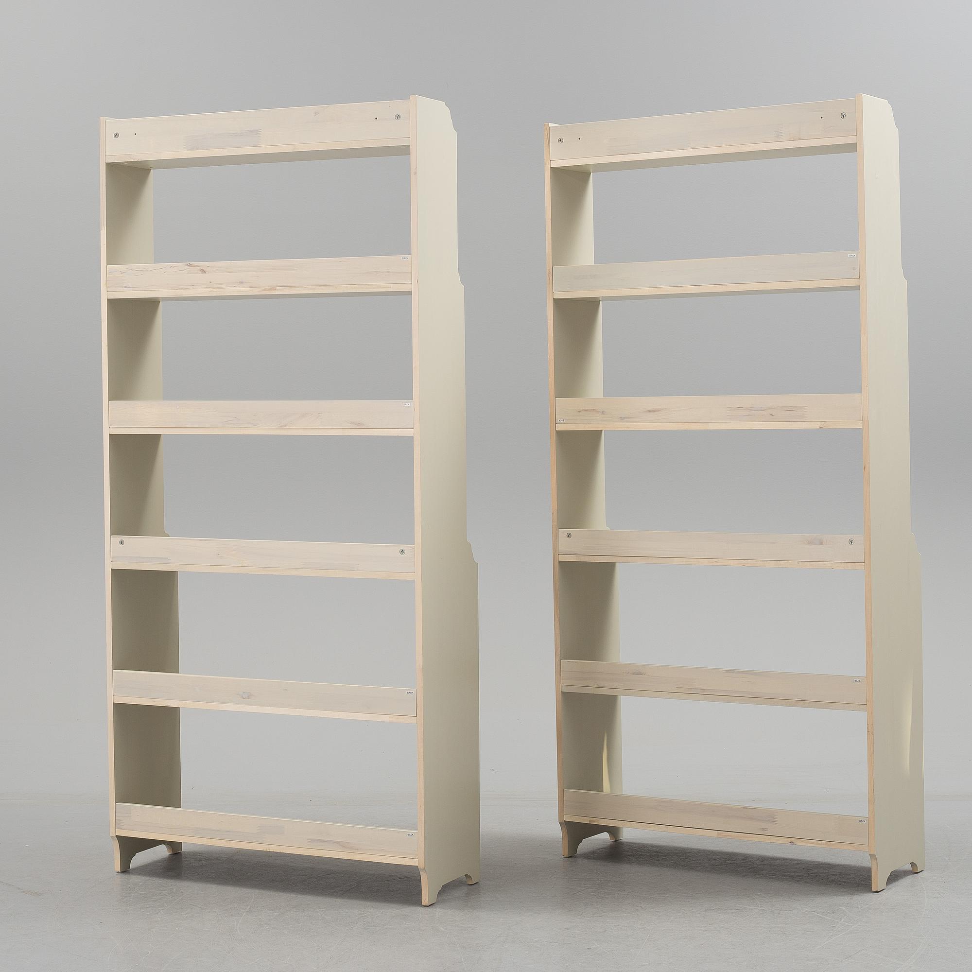 A pair of IKEA "Leksvik" painted bookcases.