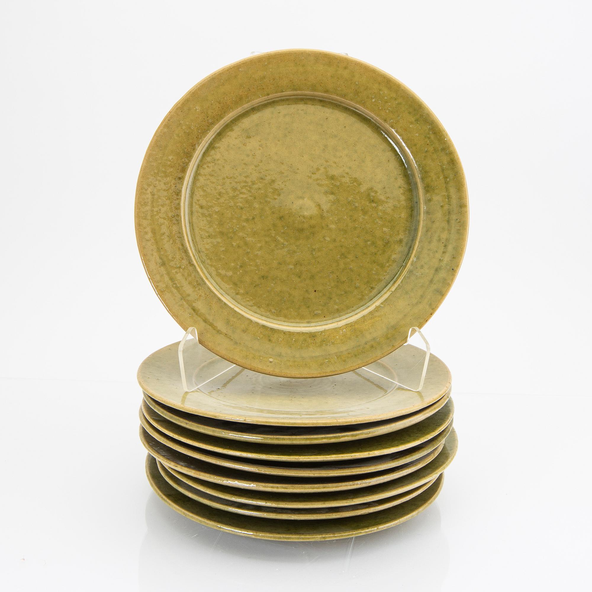Signe Persson-Melin, a set of nine 1950s kopper glazed stoneware plates.