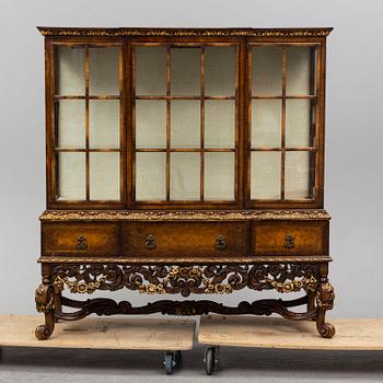 a baroque-style vitrine cabinet from the first half of the 20th century.