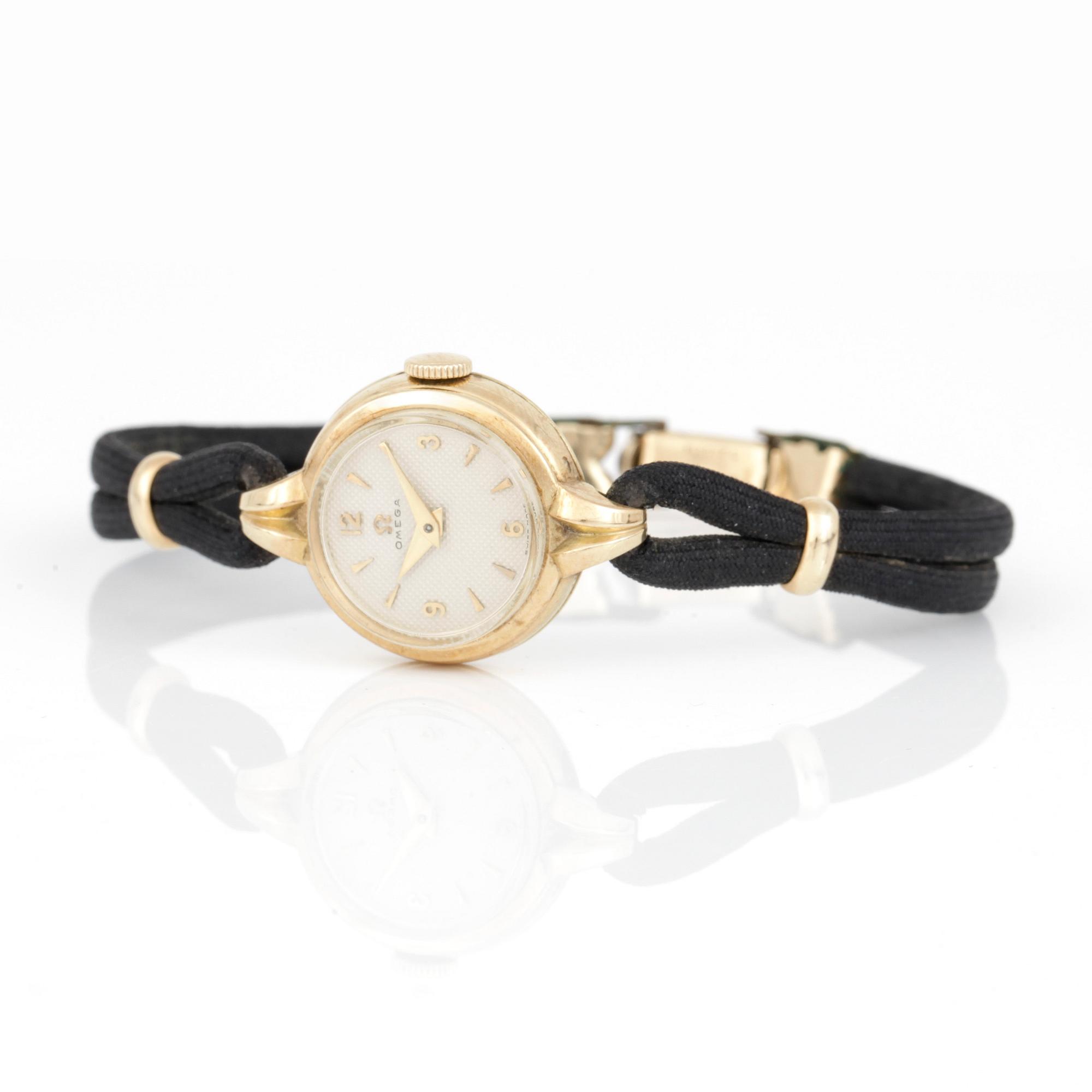 DAMARMBANDSUR, Omega, 1940-tal, boett 14 k guld.