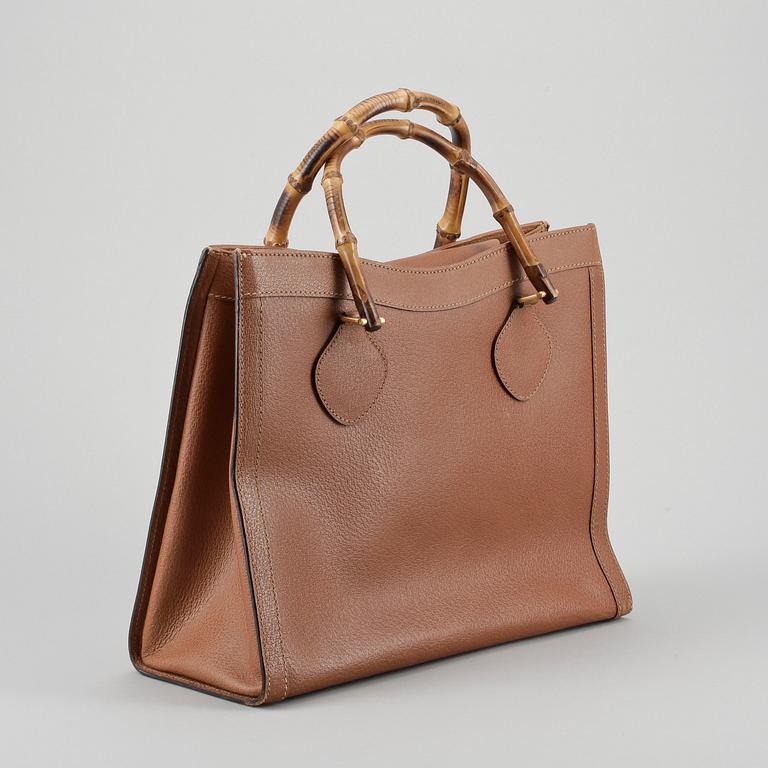 GUCCI, a brown leather imitaion handbag with bamboo handles.