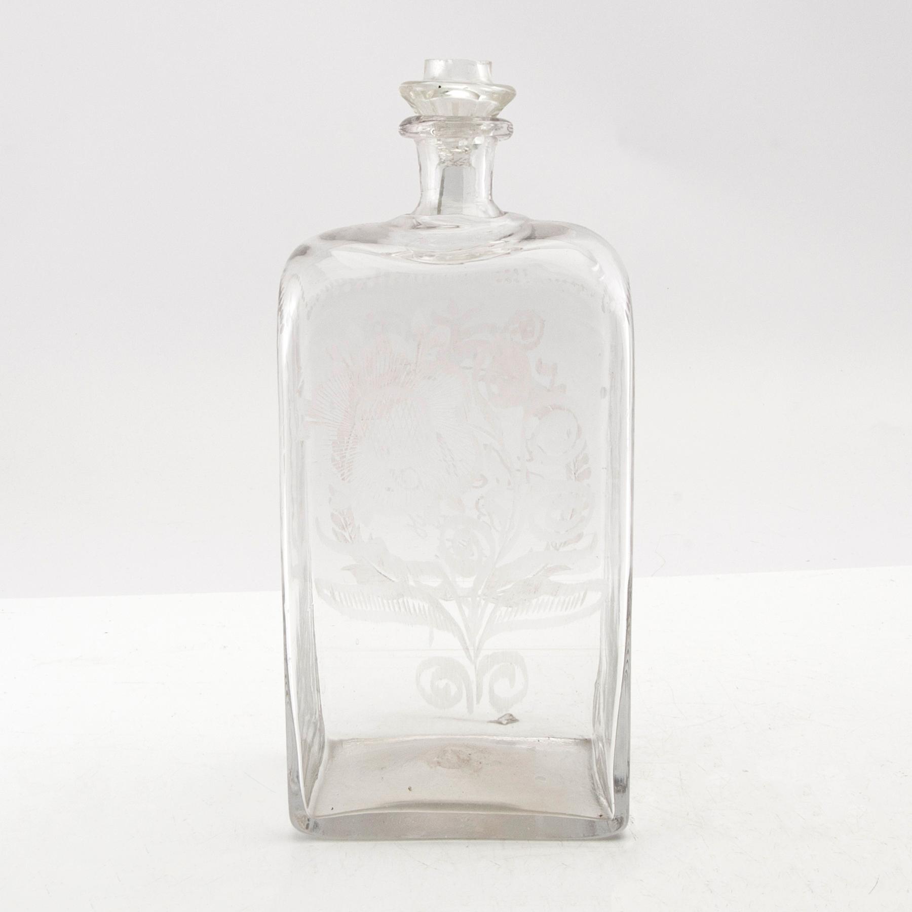 Brännvinsflaska, glas. Daterad Broby 1856.