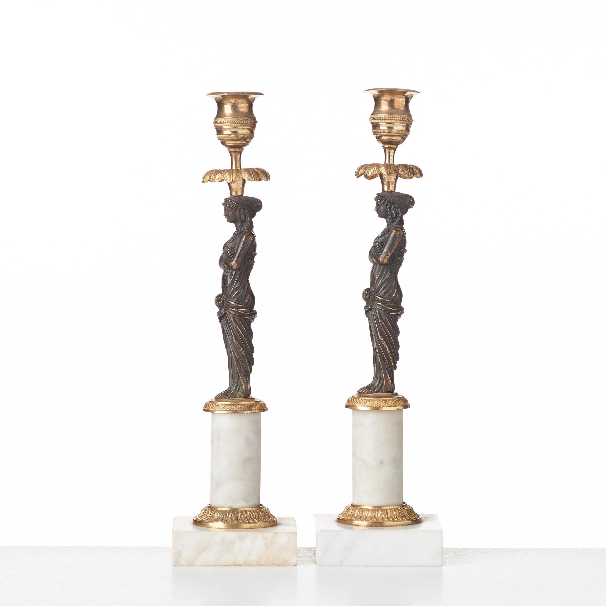 A pair of late Gustavian circa 1800 white marble and bronze candlesticks.