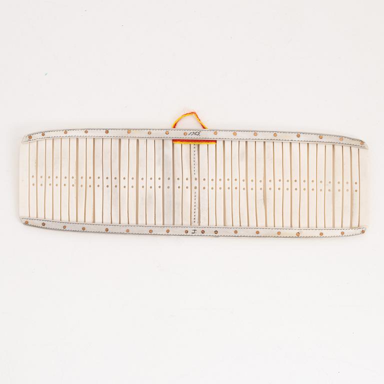 A reindeer weaving device by Johan Tuuri, signed and dated 1965.