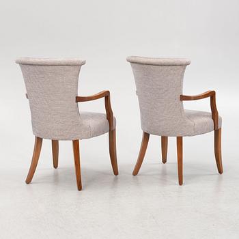 A pair of stained beech armchairs, 20th Century.