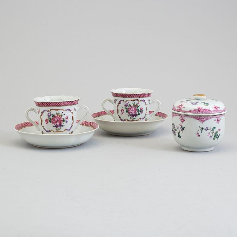 A pair of famille rose cup with stands and a sugar bowl with cover, Qing dynasty, Qianlong (1736-95).