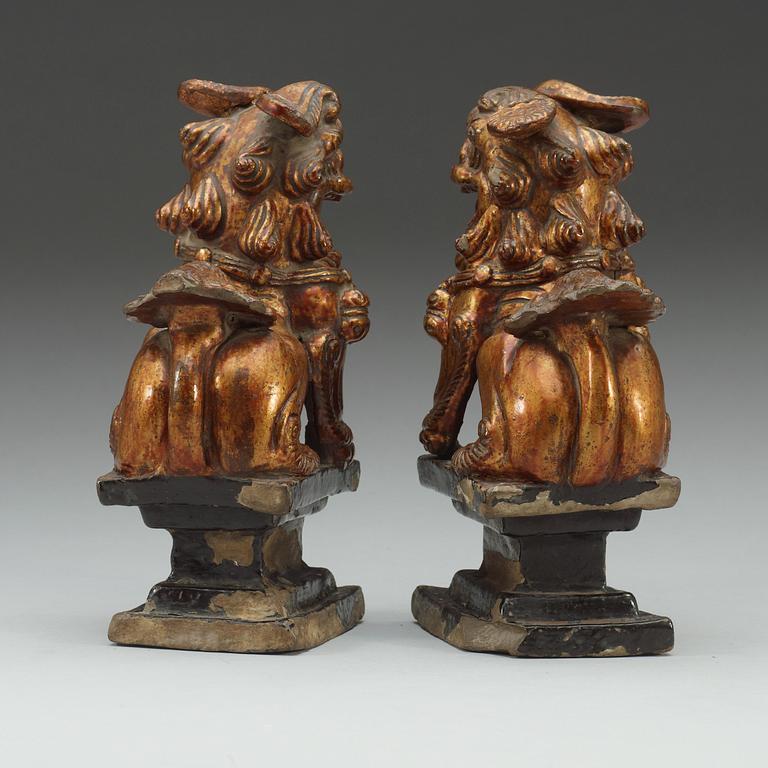 A pair of gilt ceramic figures/censer stick holders, Qing dynasty (1644-1912).