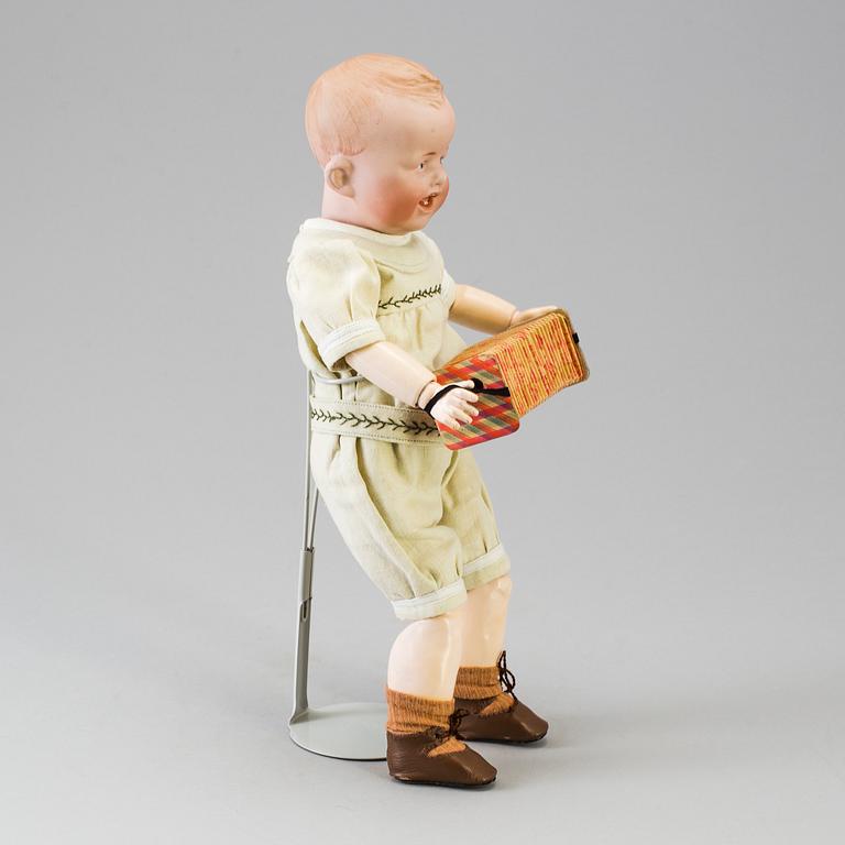 A bisque headed boy doll by Heubach, Germany, 1910s.