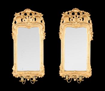 A pair of Swedish Rococo 18th century two-light girandole mirrors.