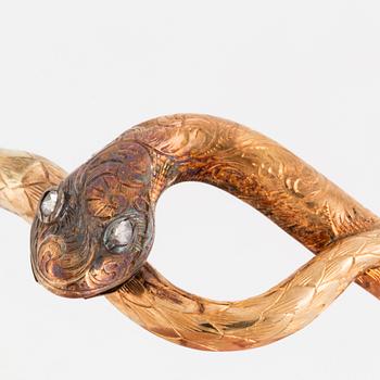 An 18K gold snake bangle with rose-cut diamonds.