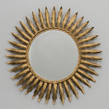 A 20th century metal sun mirror.