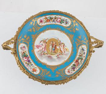 A French porcelain and brass centrepiece, second half of the 19th Century.