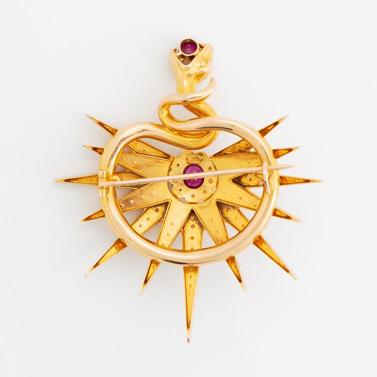 An 18K gold brooch set with two rubies, one of them likely synthetic, and pearls.