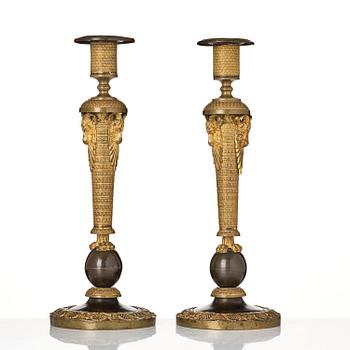 A pair of Russian Empire ormolu and patinated bronze candlesticks, Moscow circa 1800.