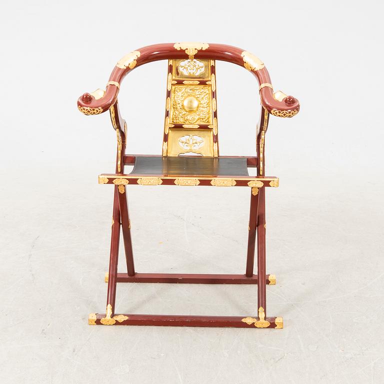 A laqcuered wooden chair from China 21st century.