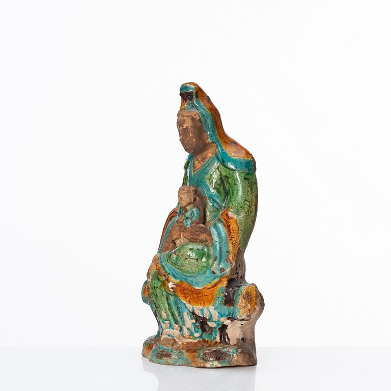 A green, turquoise, yellow and aubergine glazed figure of Guanyin, late Ming dynasty (1368-1644).