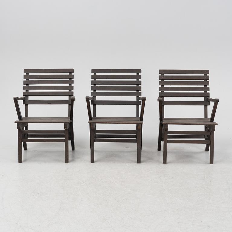 Carl Malmsten, a set three stained pine armchairs, Igelstaverken, second half of the 20th Century.