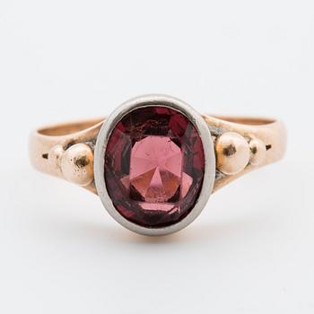 An oval-cut garnet ring.