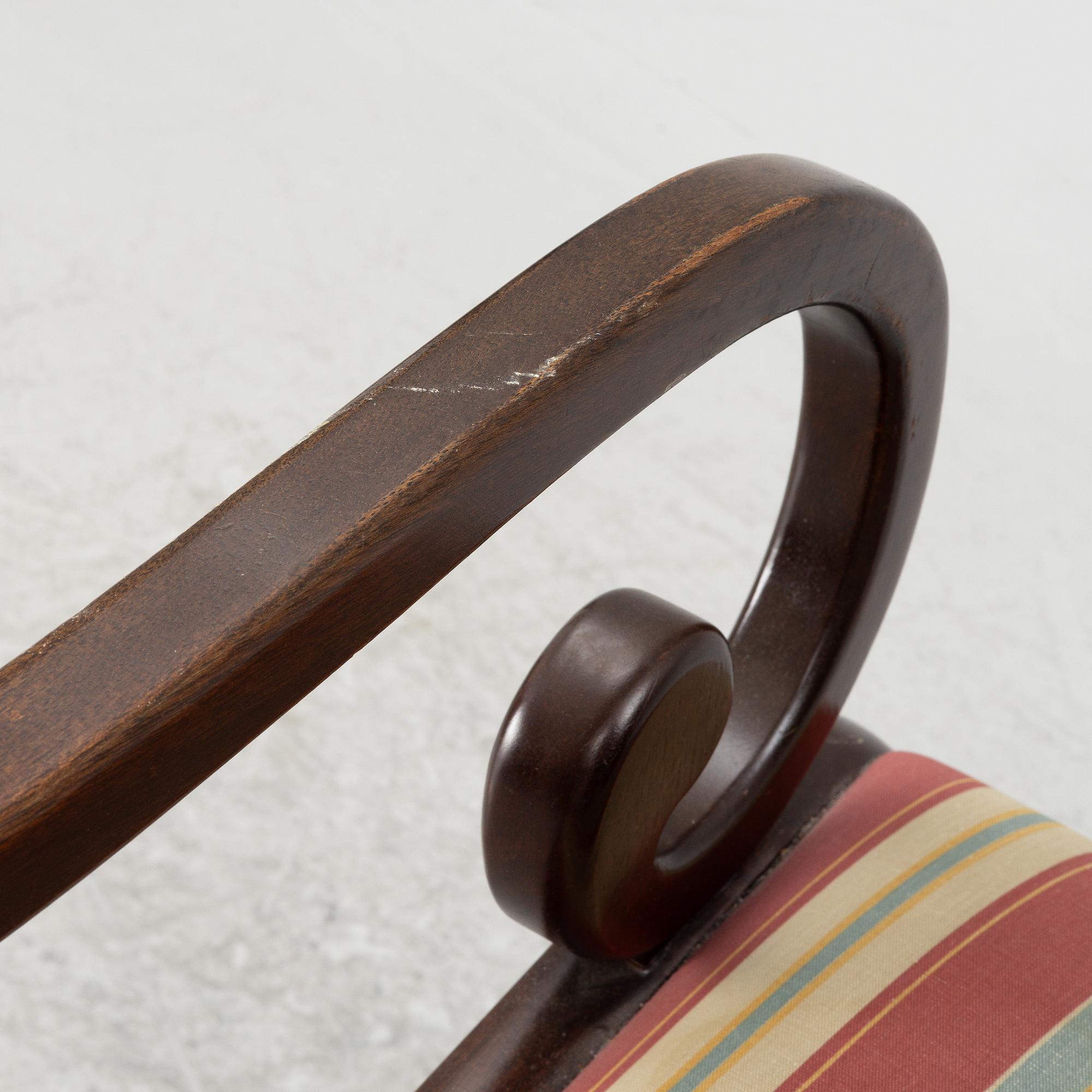 A mahogany veneer desk with desk chair, 20th Century.