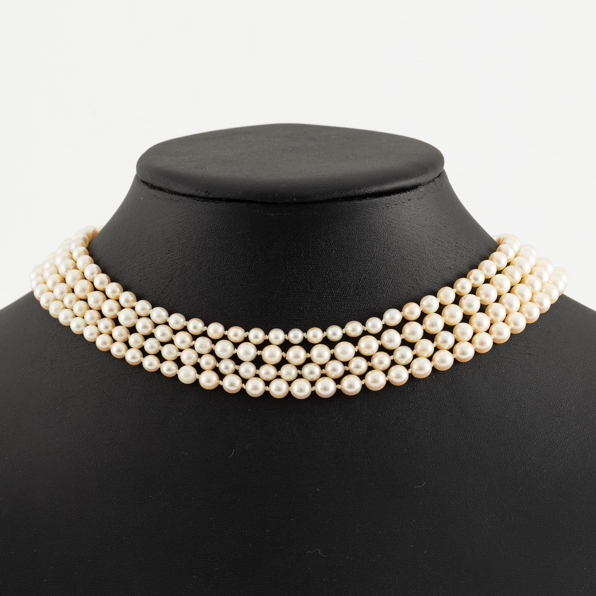 Multi-strand pearl necklace with a clasp/brooch in gold with diamonds,.