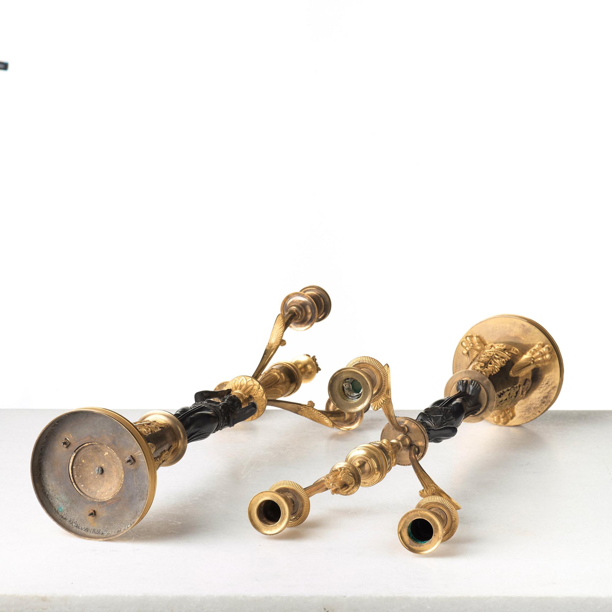 A pair of French Empire early 19th century three-light candelabra.