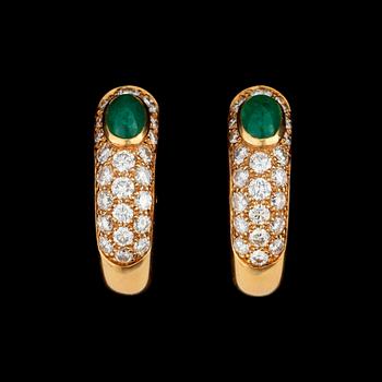 1115. A pair of Cartier earrings set with emeralds and brilliant cut diamonds.