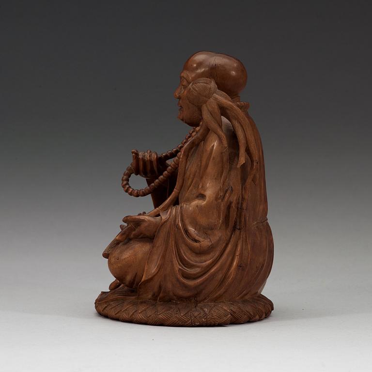 A Chinese wooden figure of a daoist dignitary.