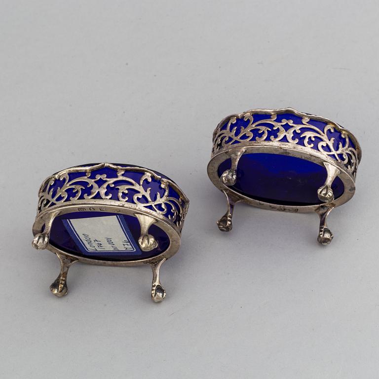 A pair of English 18th century silver and blue glass salt-cellars, unidentified makers mark, London 1767.