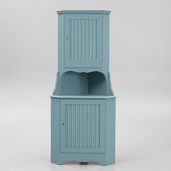 A corner cabinet, 20th century.