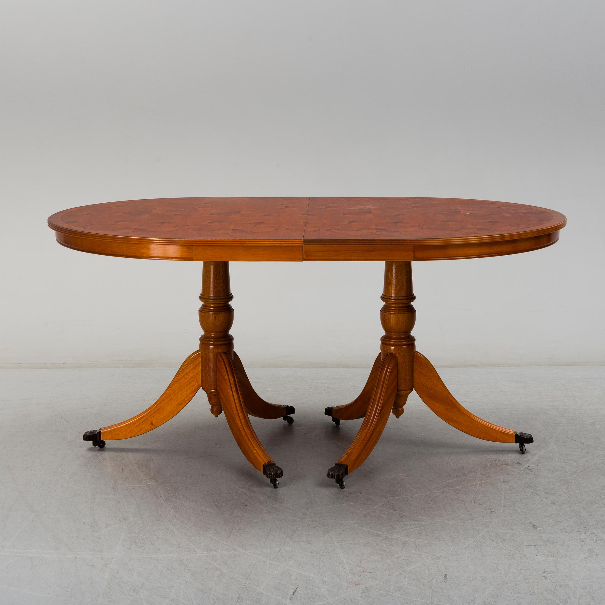 A late 20th century English style dining table and six chairs.