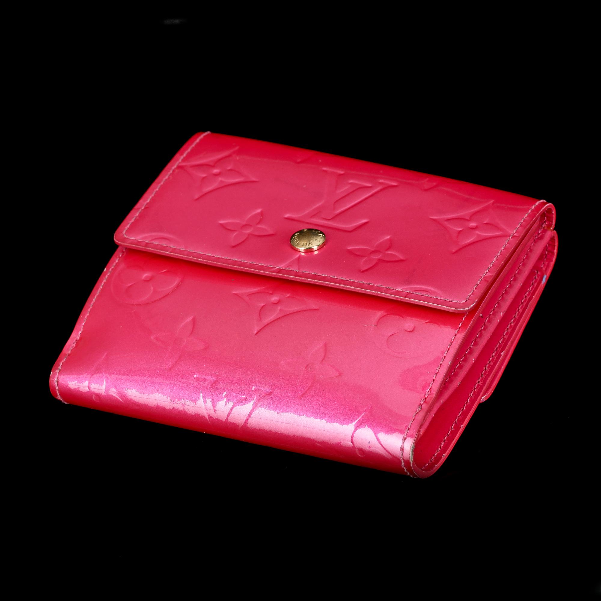 A cerise monogram vernis wallet by Louis Vuitton.