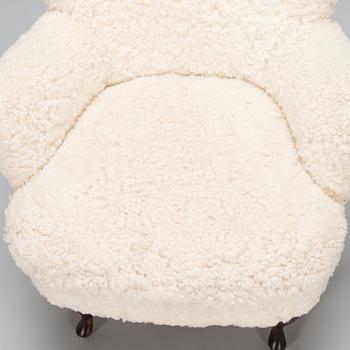 A contemporary sheepskin upholstered lounge chair, ABC collection.