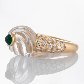 A Boucheron ring set with a carved rock crystal, a cabochon-cut emerald and round brilliant-cut diamonds.