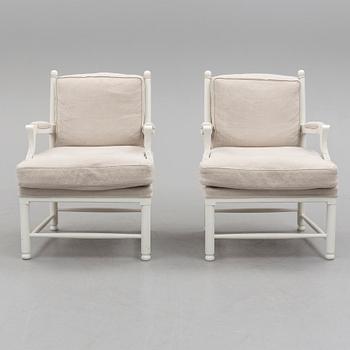 A pair of second half of the 20th century arm chairs.