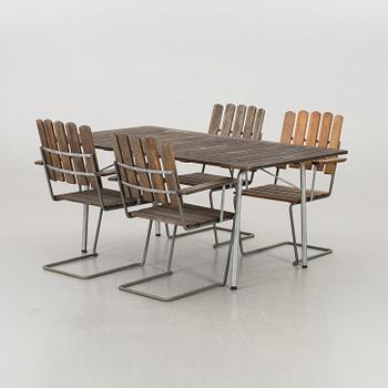 A GARDEN TABLE AND FOUR ARMCHAIRS FORM GRYTHYTTAN.