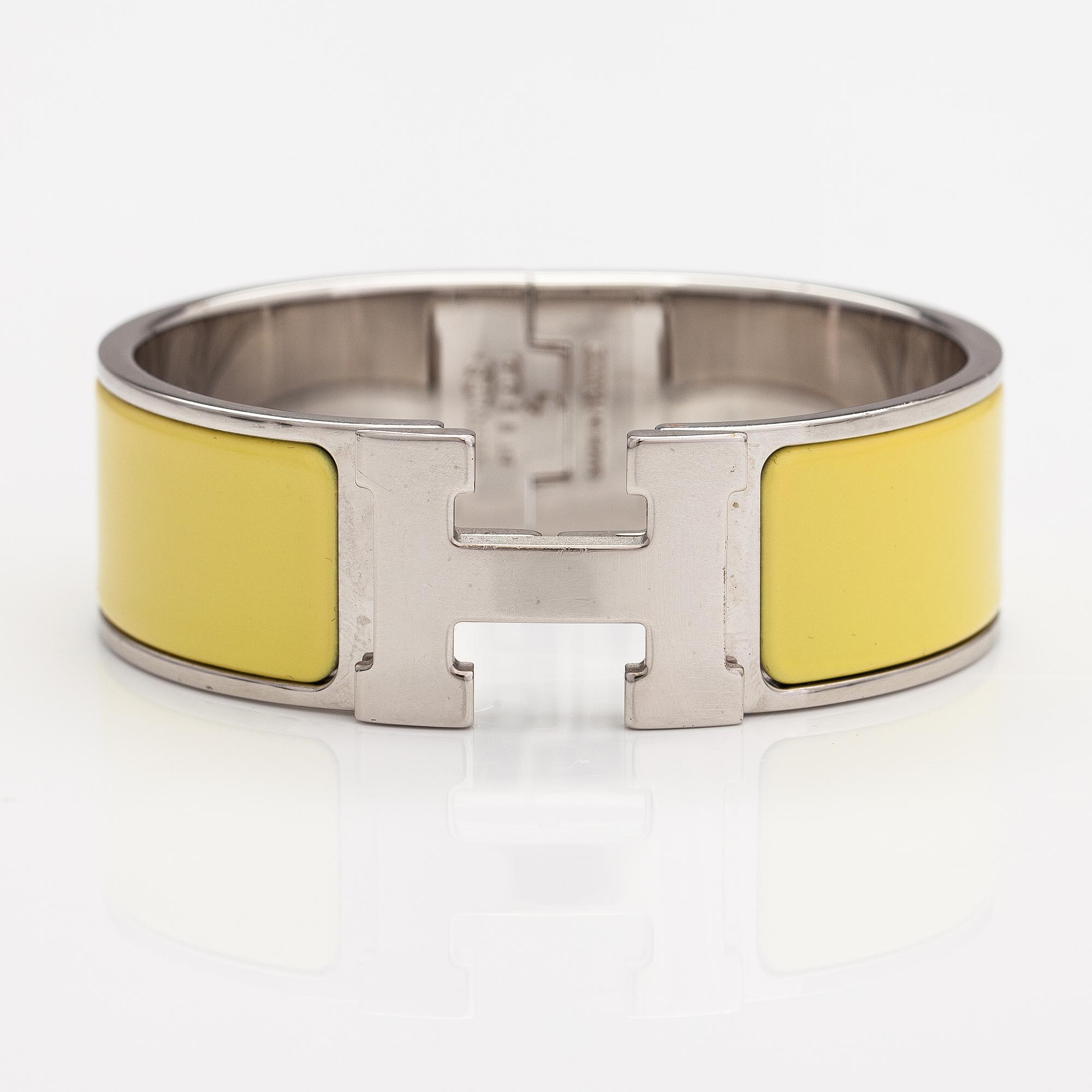 Hermès, A "Click H" bracelet made of metal and yellow enamel. Marked Hermès, ST1105, S, Made in France.