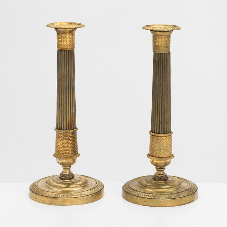 A pair of Empire style candlesticks, early 19th century.