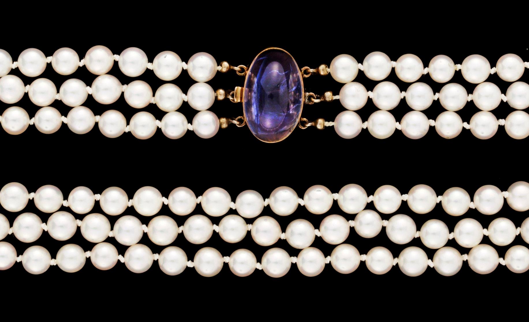 A three strand cultured pearl necklace.