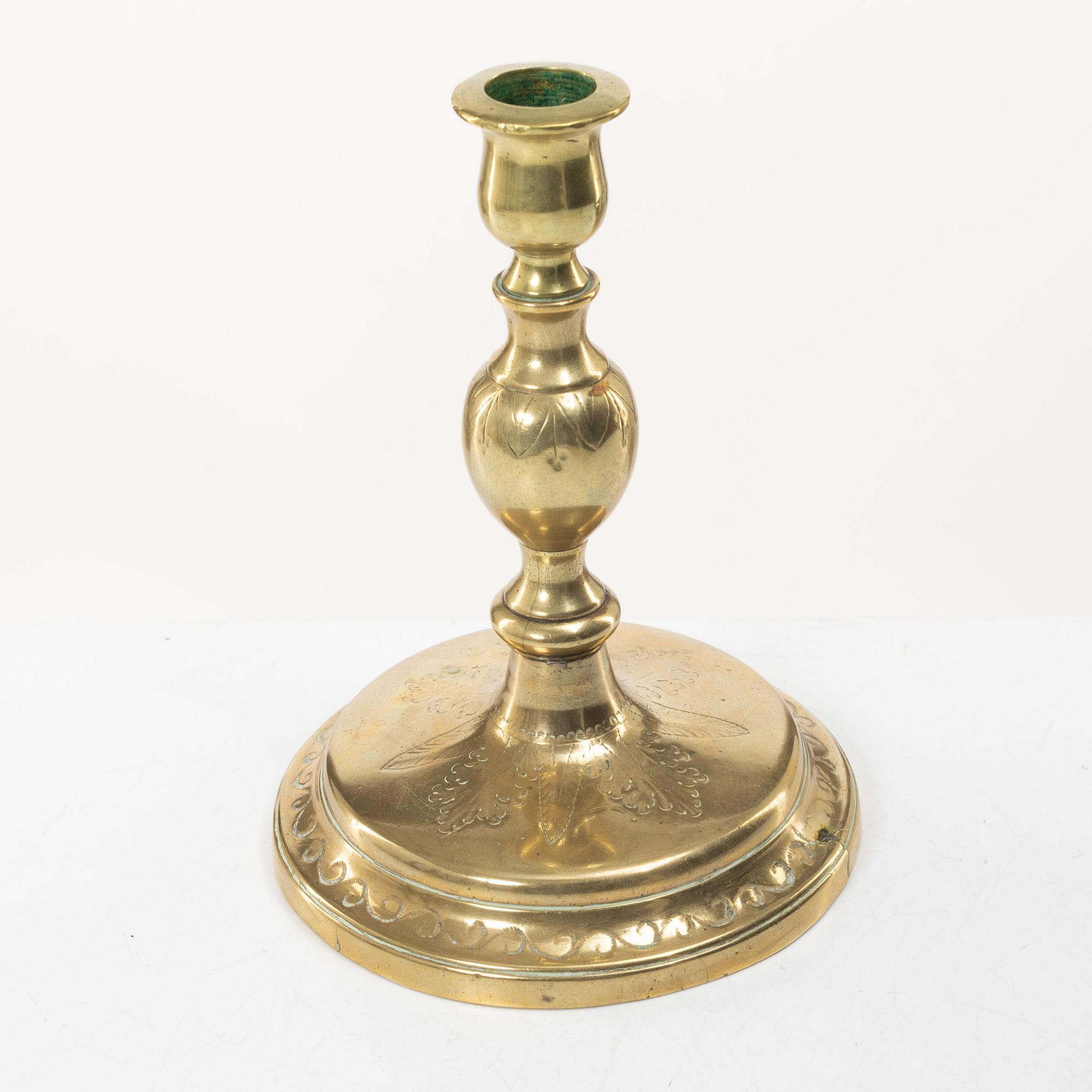 A candle holder in brass, Baroque, 17th/18th century.