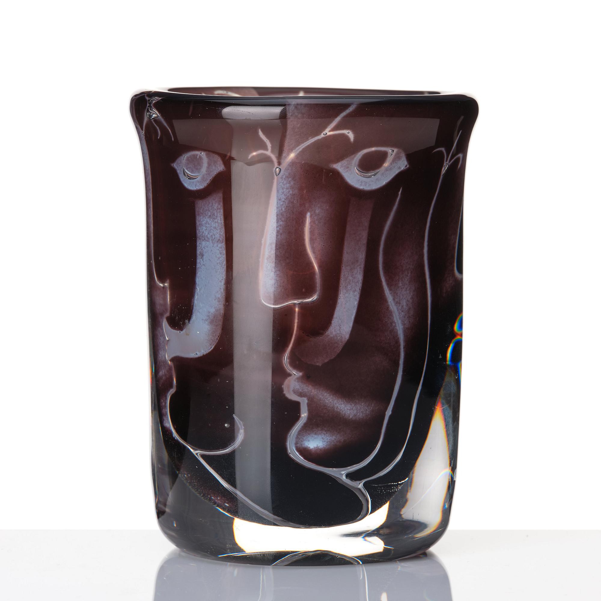 Ingeborg Lundin, an 'ariel' burgundy coloured glass vase decorated with faces, Orrefors Sweden 1972.